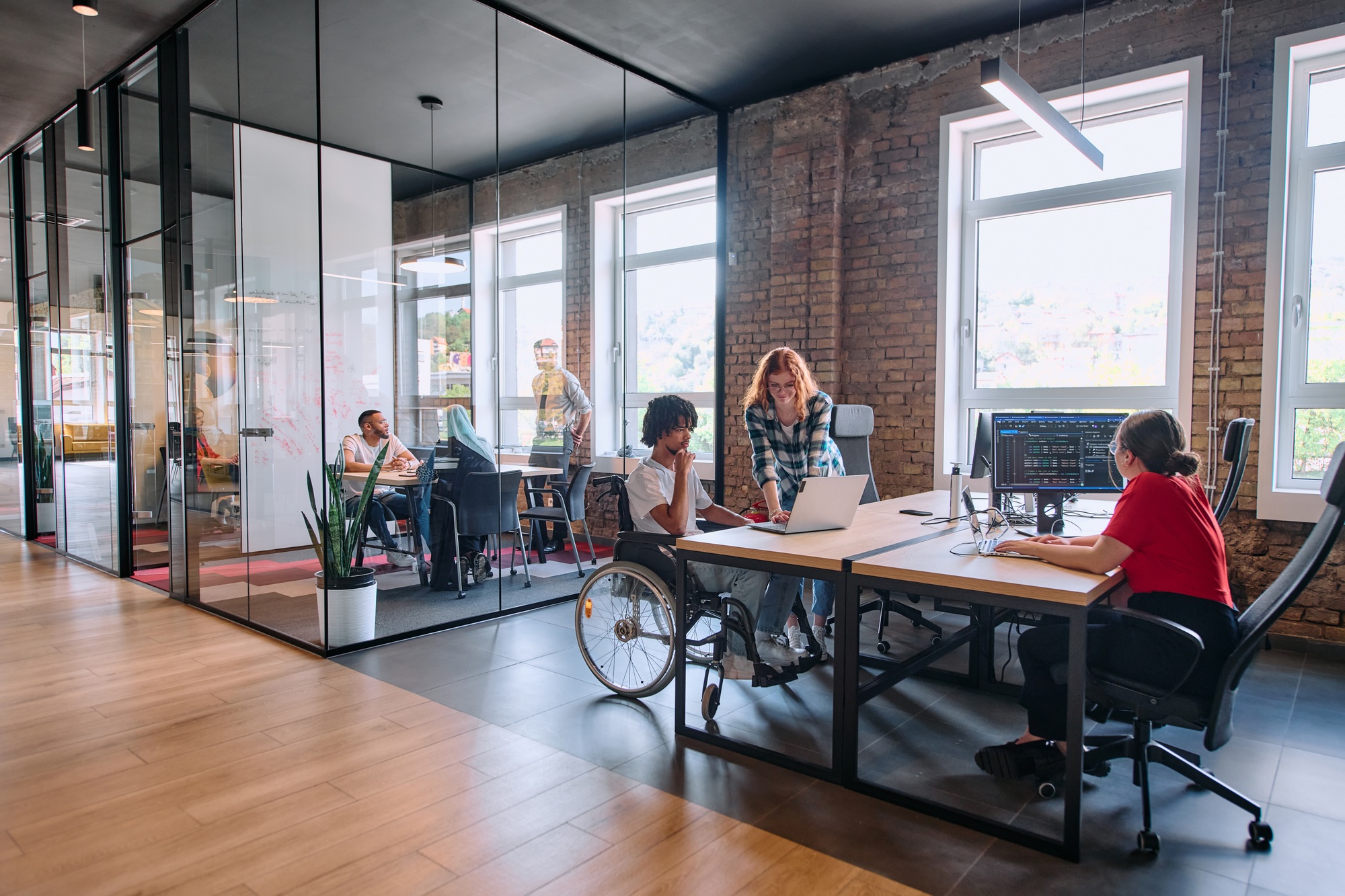 A diverse group of business professionals collaborates in a modern startup coworking center