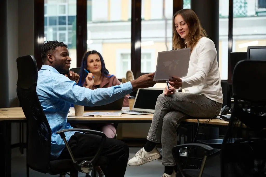 African American man and caucasian women working on logo development