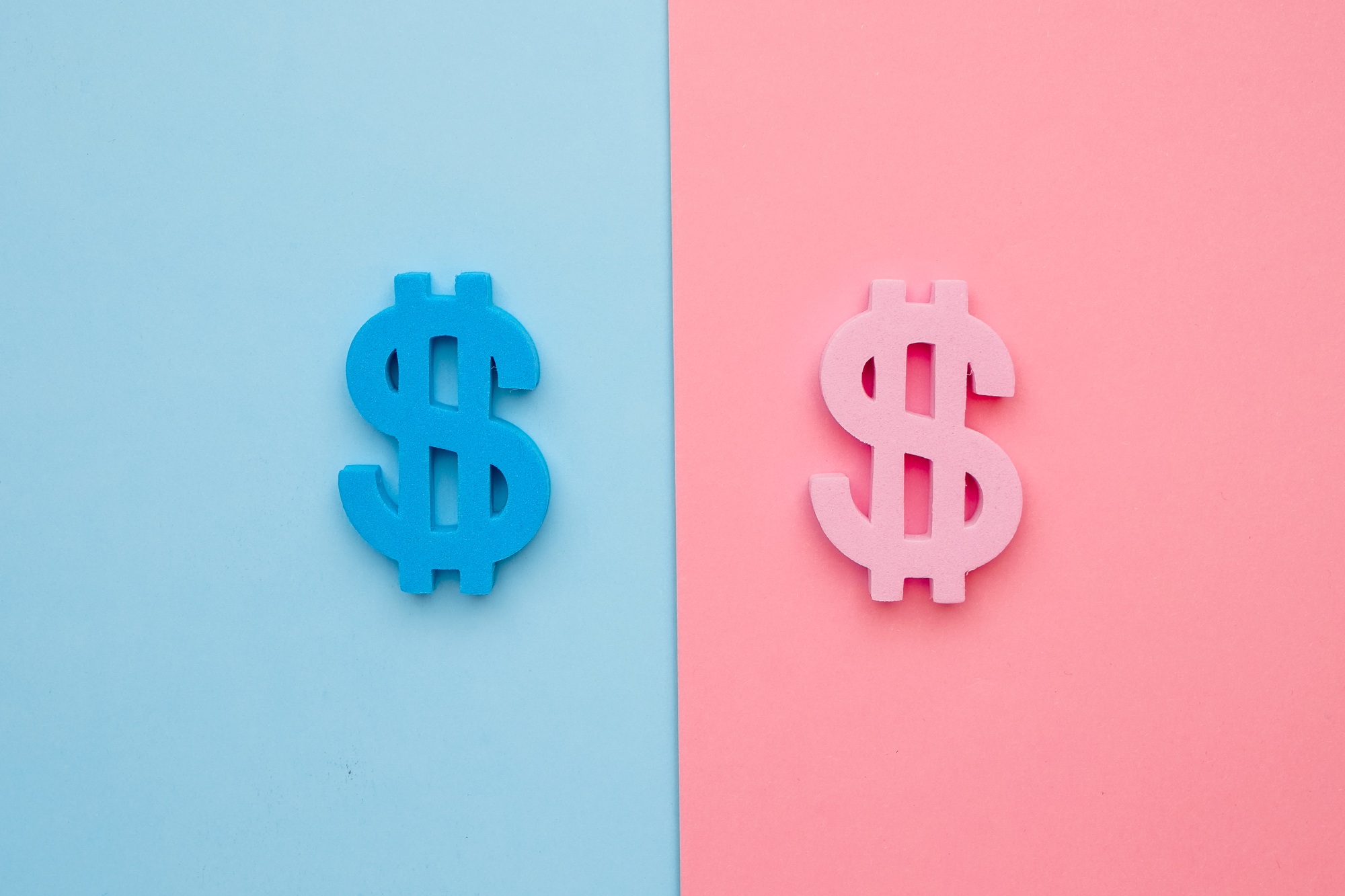 American dollar symbol on blue and pink background, minimal flatlay