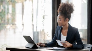 American woman sits in the office of a startup company.