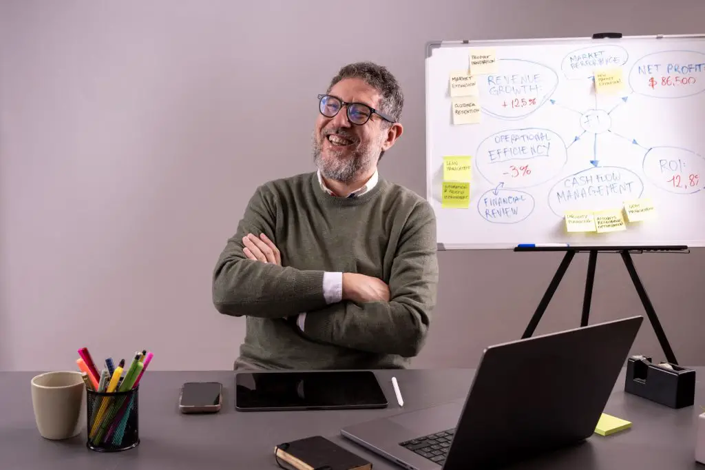Business executive discussing market performance on whiteboard, financial growth concept