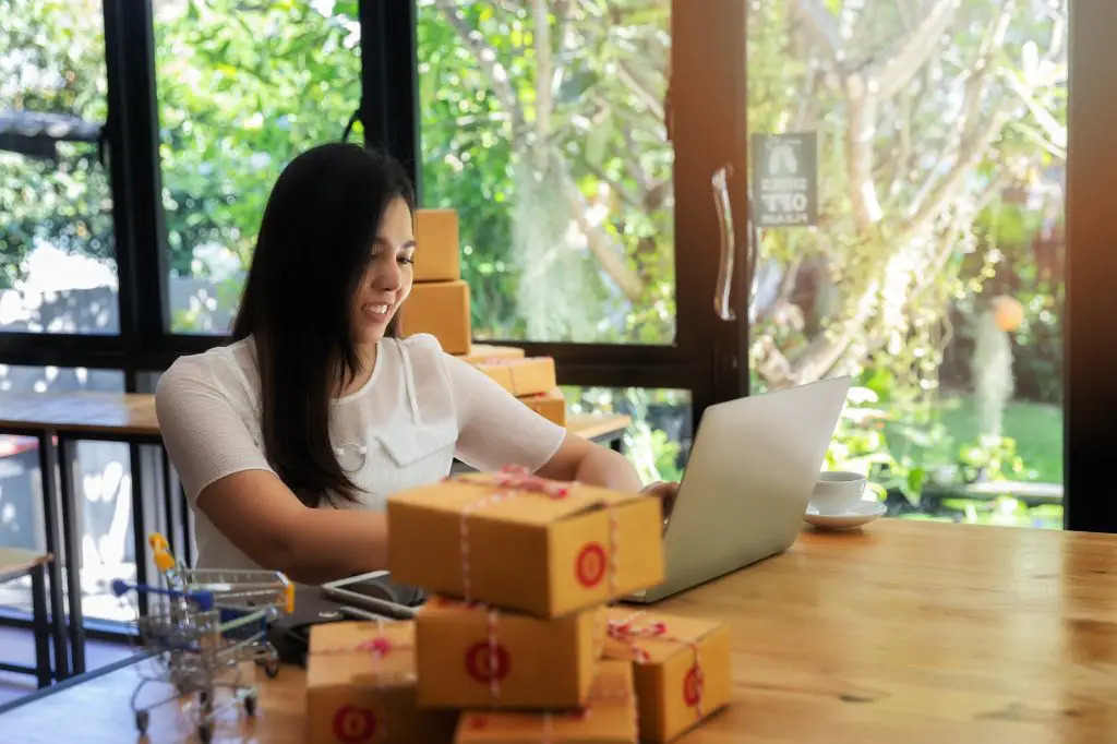 business woman with online sales and Parcel shipping in her home office.