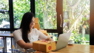 business woman with online sales and Parcel shipping in her home office.