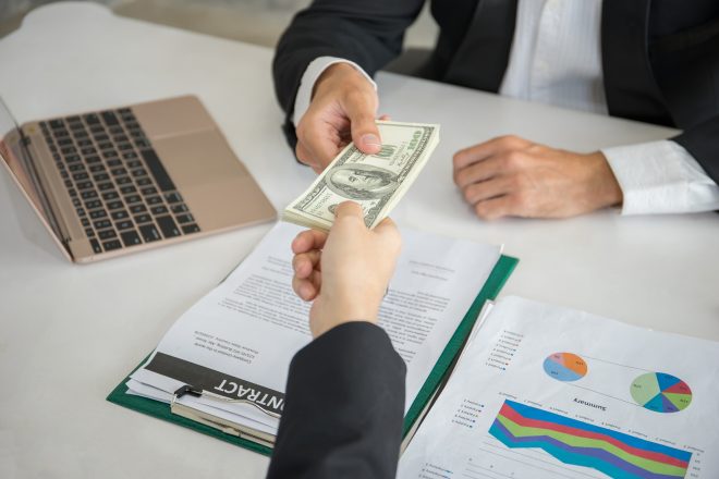 Businessman get dollar money bribery in office. corruption concepts.