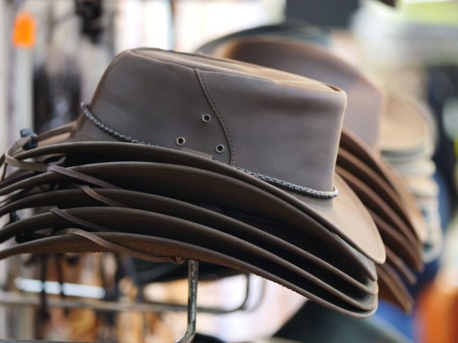 Close-up shot of a set of leather cowboy hats in the street shop