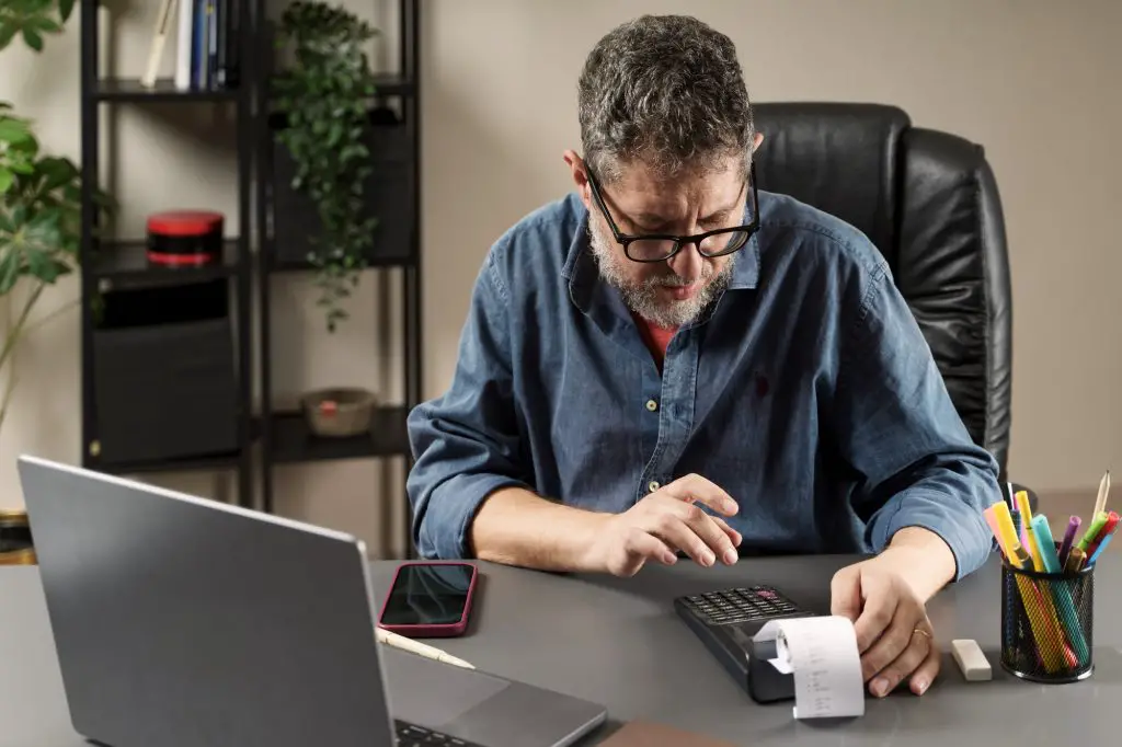 Focused Accountant Calculating Budget
