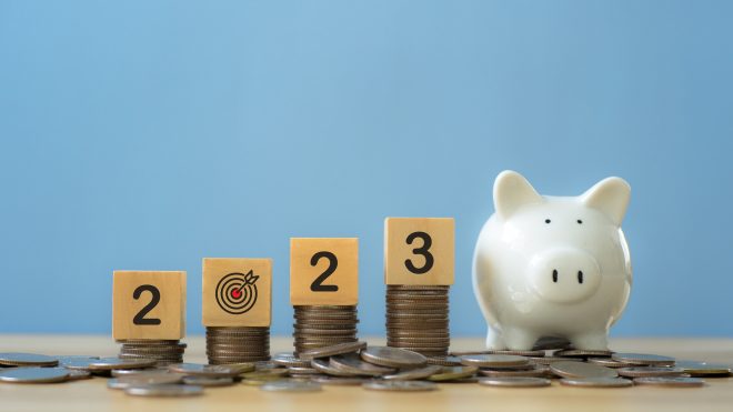 Goal in the new year 2023.2023 word on wooden cube on coins.Resolution, time, plan, goal.