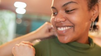 Happy face of a female client in a sewing workshop