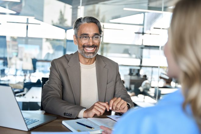 Happy middle aged business man hr having job interview onboarding meeting.
