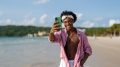 Influencer taking a selfie on a tropical beach, enjoying vacation, social media content creation