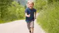 Joyful child running on a sunny nature trail
