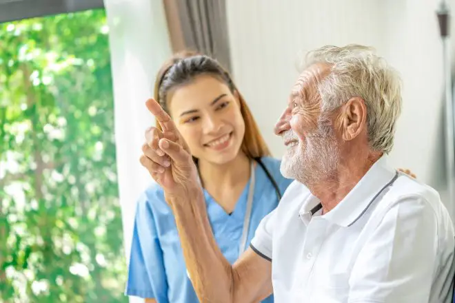 Man being cared for by a private Asian nurse at home