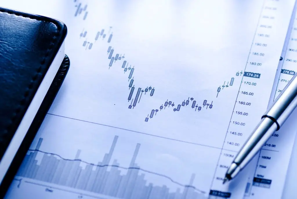 Open journal with business graphs and pen