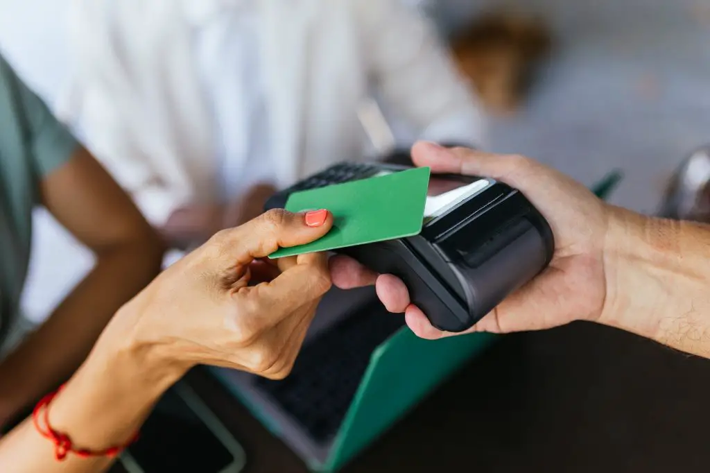 Secure Card Payment. Hand with POS Terminal Receives Payment
