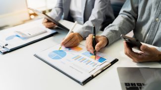 Teamwork process, Business team using a calculator to calculate
