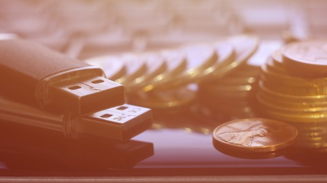 USB flash cards lying on black laptop case in front of his keyboard