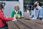 Young happy trendy friends recording online podcast and sharing content on streaming platform